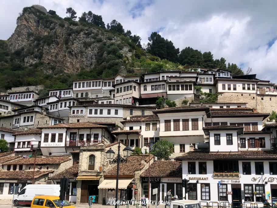 view of Albanian homes on hill side with many windows in Berat