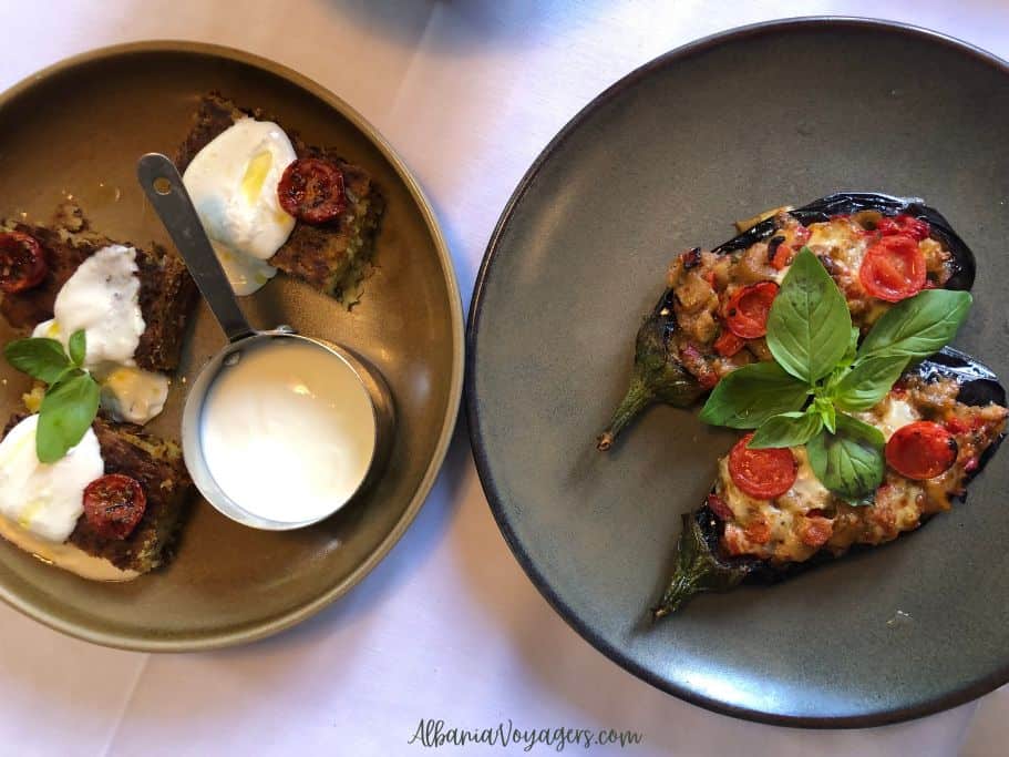 plates of stuffed eggplant and leek pie with yogurt dressing at Era Piceri in Tirana