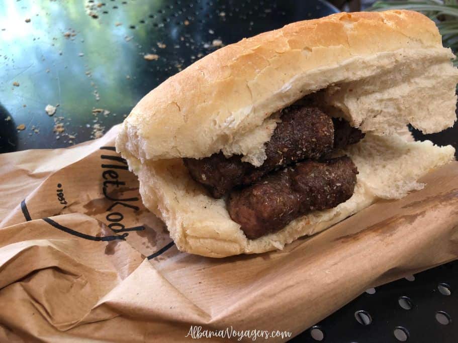 white bread with 3 grilled qofte inside ona brown paper bag at Te Met Kodra in Tirana
