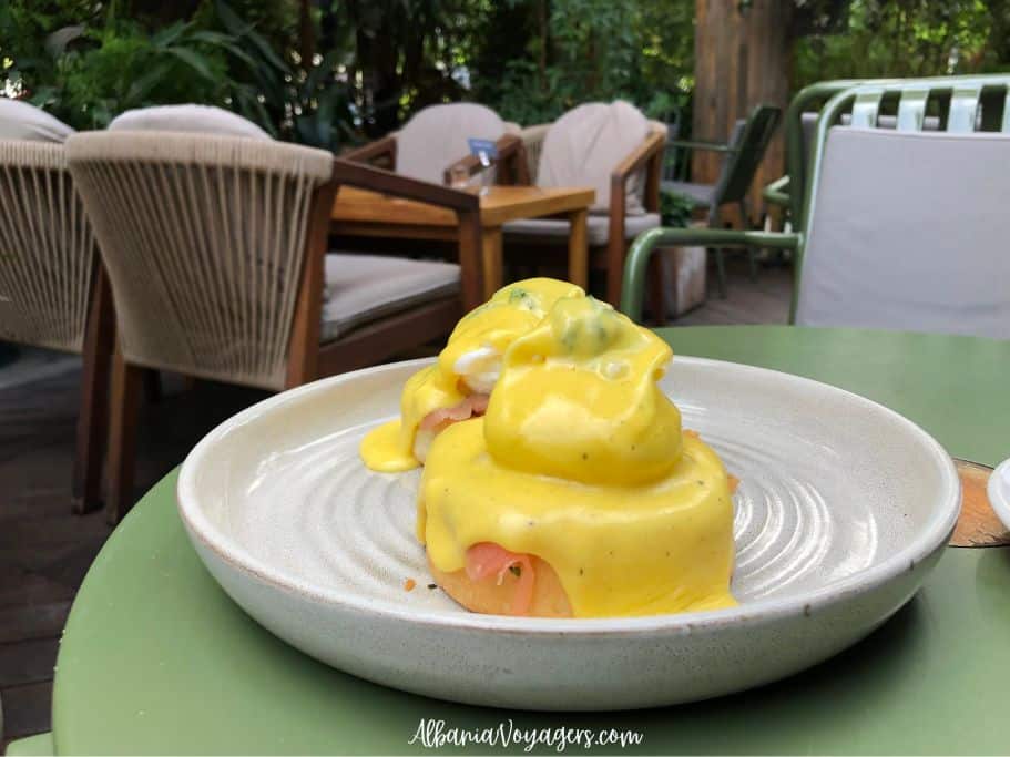 close up of eggs benedict with salmon on white plate at Mulliri Gourment in Tirana
