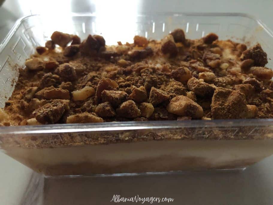 clear plastic container of ekmek with toasted nuts on top in TIrana