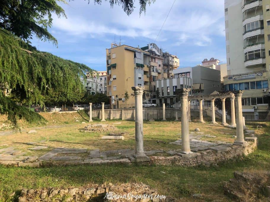 columns in circular formation with apartment buildins around them in Durres, Albania