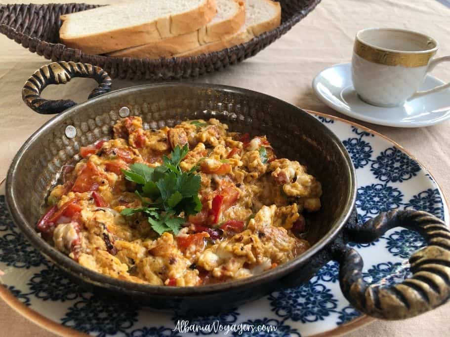 fancy copper dish with menemen, bread and cup of coffee at Otantik Turkish Restaurant by Durres Beach