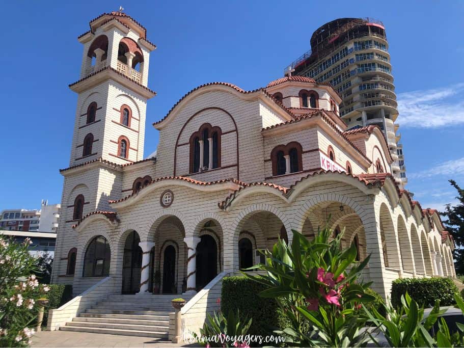 full front view of Church of Apostle Paul in Durres, Albania with flowers in foreground