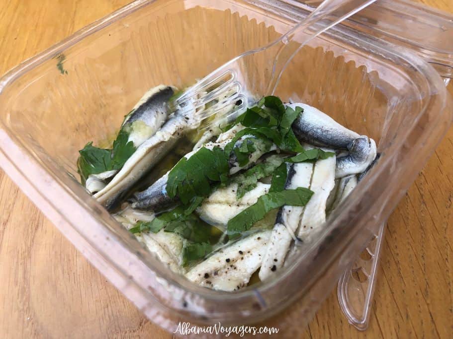 clear plastic container with fresh sardine crudo and parsley at Peshk i Fresket Bracja 2 in Durres