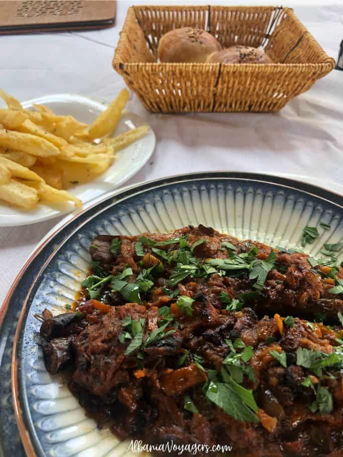 stuffed eggplant and fried potatoes at Garden Grill Restaurant in Ksamil