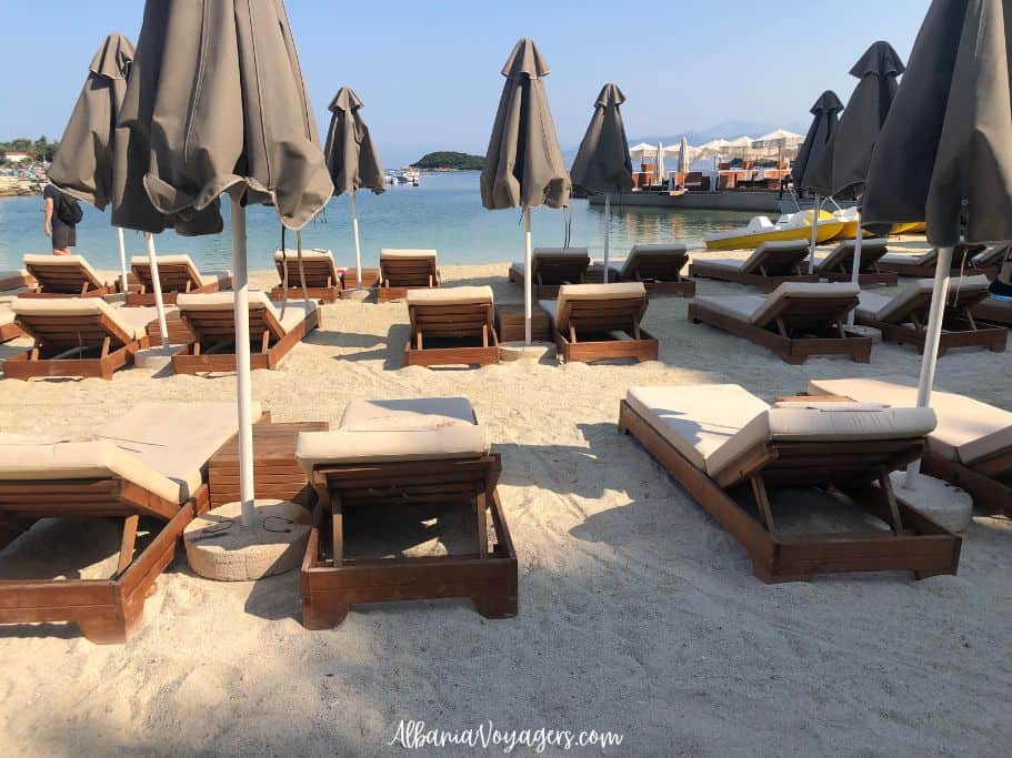 Paradise Beach in Ksamil with rows of loungers and umbrellas 