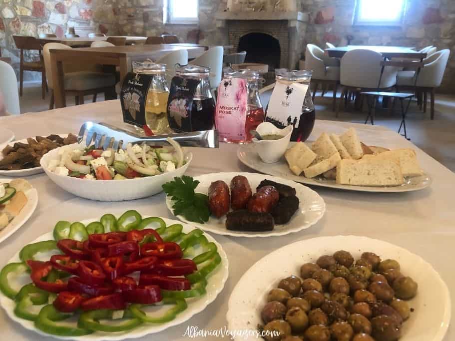 table full of food and karafes of wine at Agrotourism Isak in Saranda
