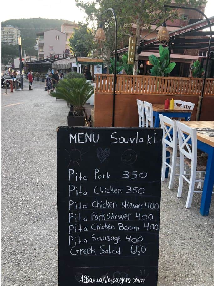 blackboard menu sign on beach promenade in Himare