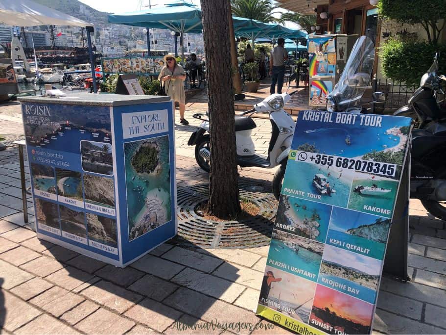 sandwich board and stands advertising boat tours in Saranda
