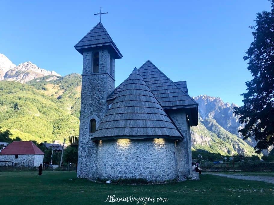 Stone church with wood room and tall tower in Theth, the Church of Theth