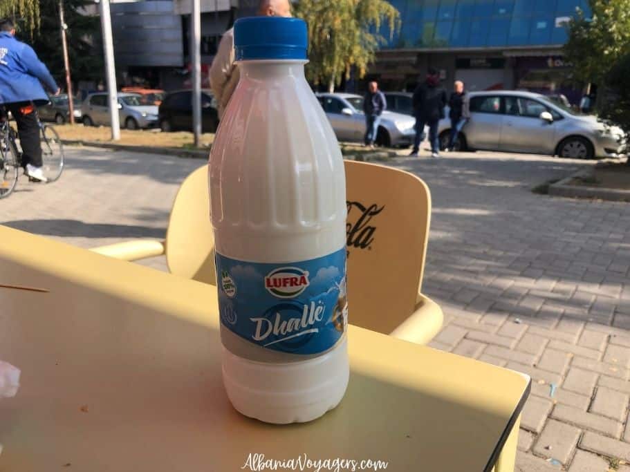 bottle of dhalle on yellow table outdoors in Korce