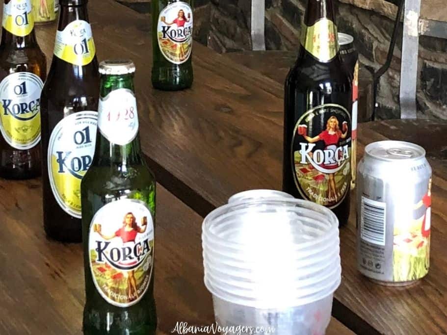 bottle of blonde and dark Korca beer on a wooden table at the Korca Birra factory in Korce