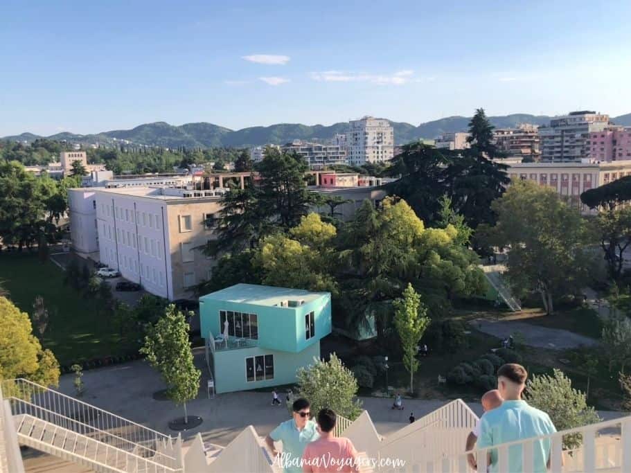 view looking over Tirana with from the Pyramid and people climbing up the stairs