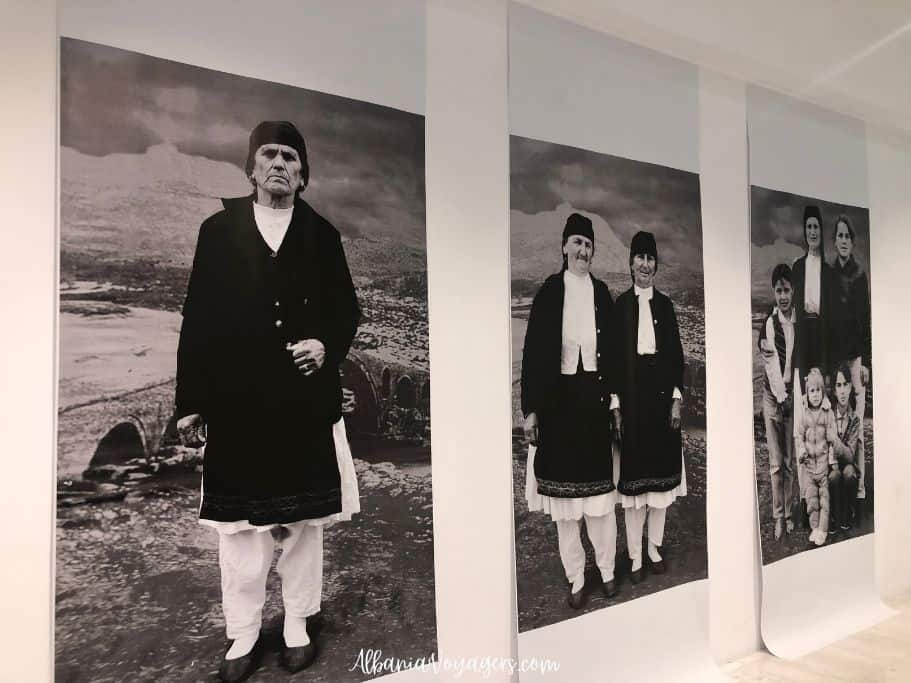 three large black and white photographs of Albanians in traditional dress in the Marubi Museum in Shkoder