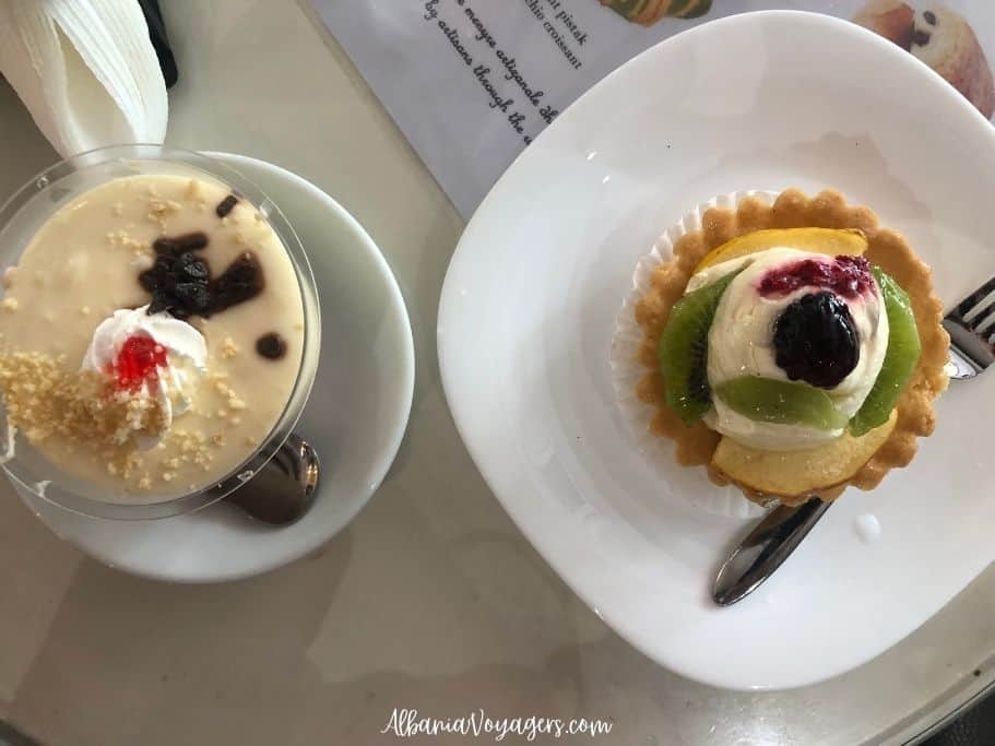 white plates with bowl of zup and tart with cream and pastry at Oraldi