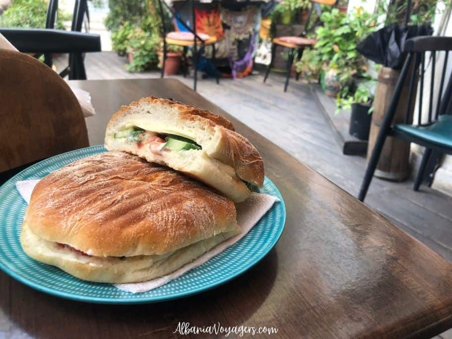 vegetable panini cut in half on blue plate at Eko Club