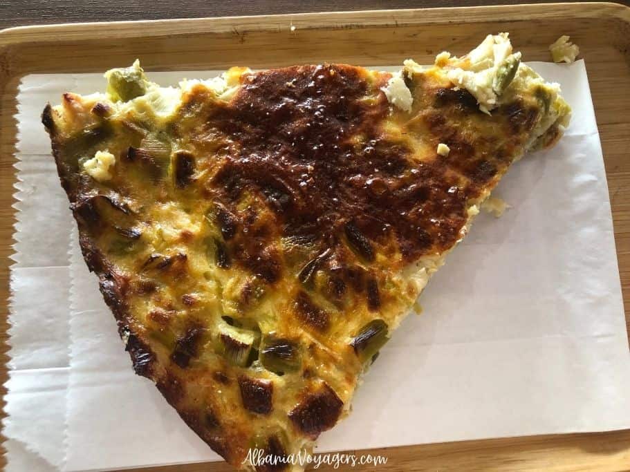 piece of leek lakror on white paper back and tray at Te Nana in Shkoder, one of best places to eat