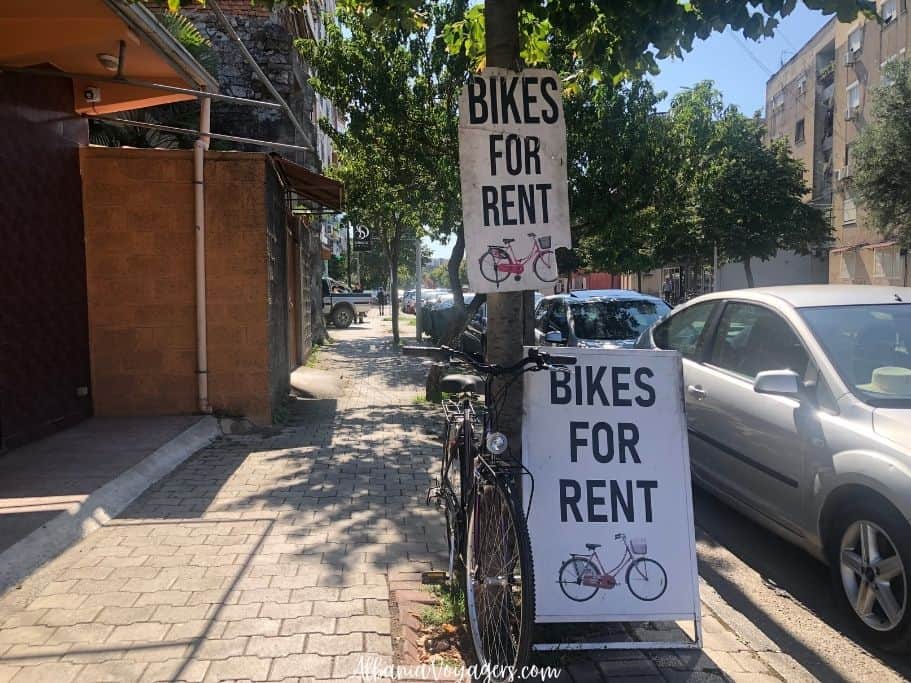 signs on the street in Shkoder to rent bikes