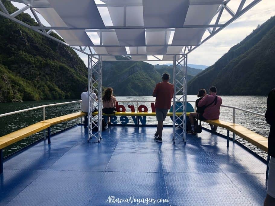 looking onto Lake Koman from the Shala River ferry with green mountains on three sides