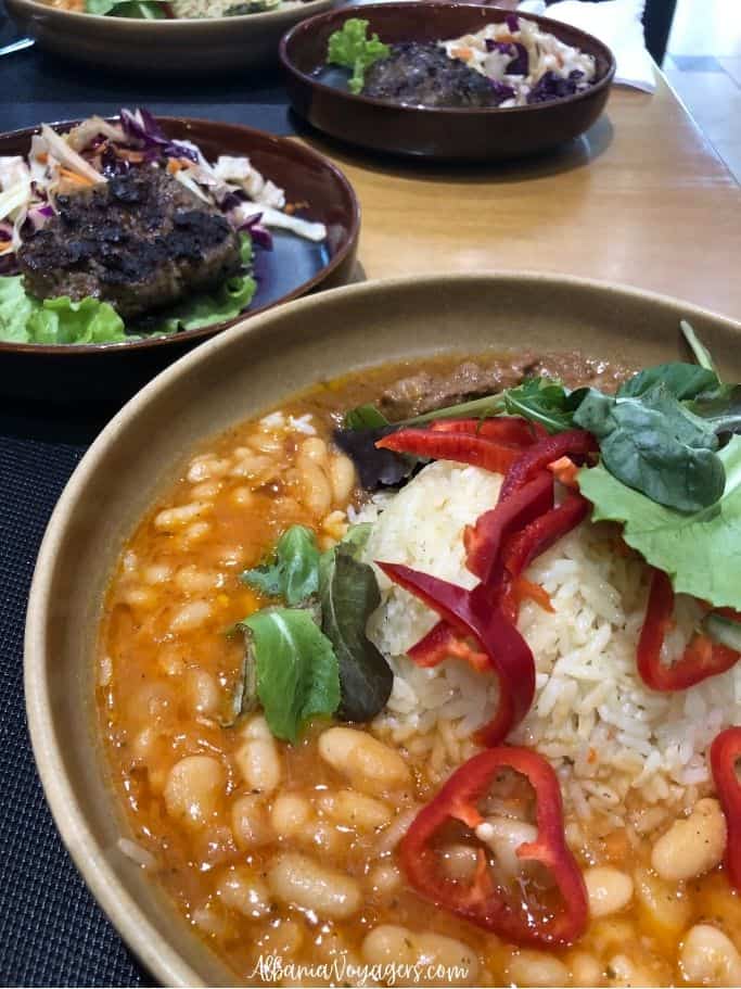 round dish with beans, rice, greens and red peppers at Puri in Shkoder