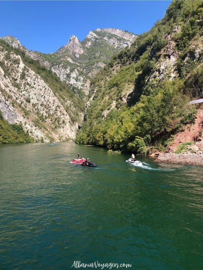 fjords of Lake Komani and jet ski in the water