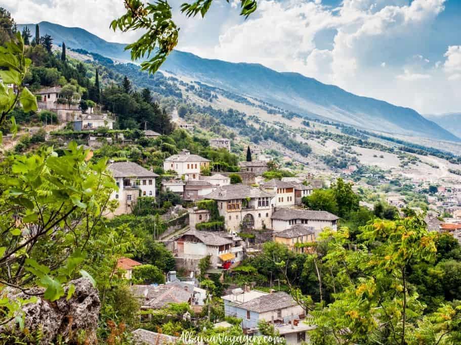 Gjirokaster on hillside with mountains in back, one of the best places in Albania