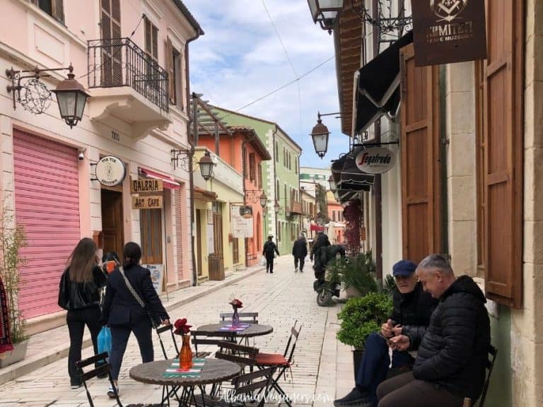 Vlore Old Town street with pedestrians and cafe tables