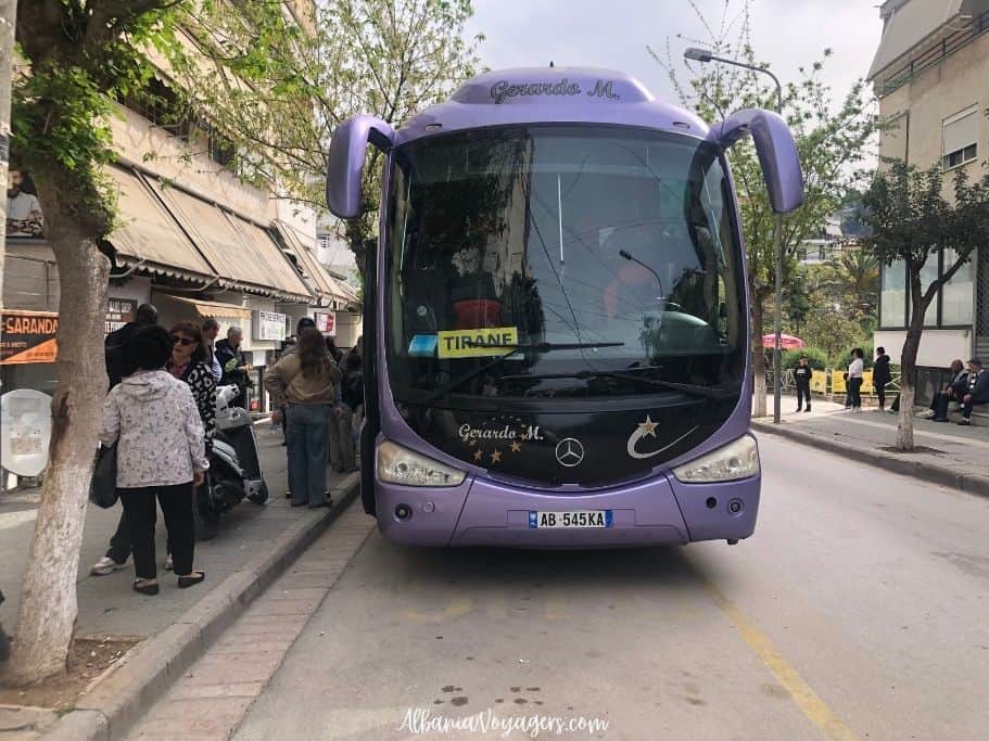 coach bus for Tirana parked on street in Saranda, safe travel for solo females