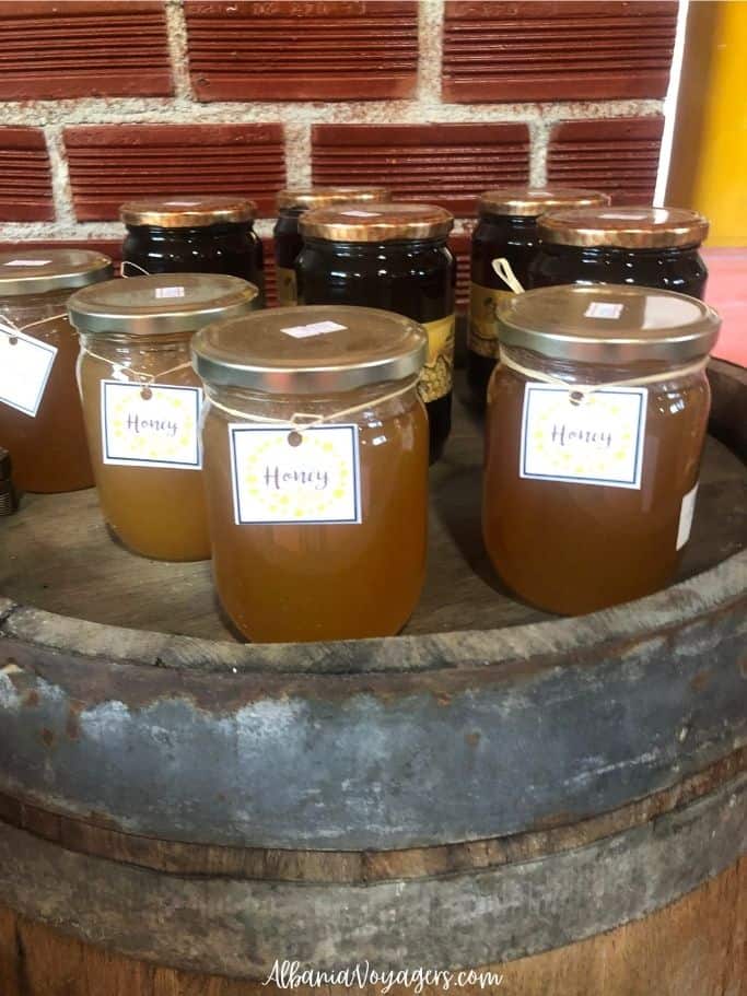 jars of honey on old barrel in the farm shop at Agrotourism Isak near Saranda