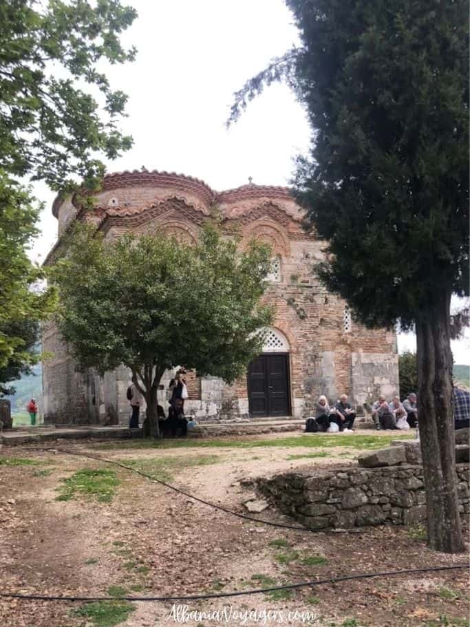 Orthodox church of St. Nikolas exterior with group eating lunch in front