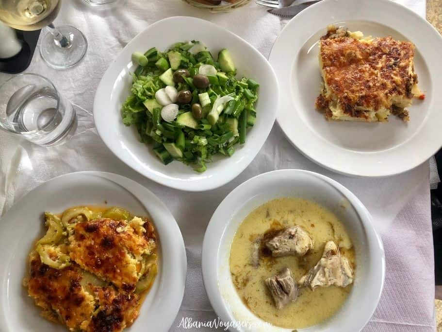 plates of food on white table cloth at Te Culi in Permet, slow food makes Permet worth visiting