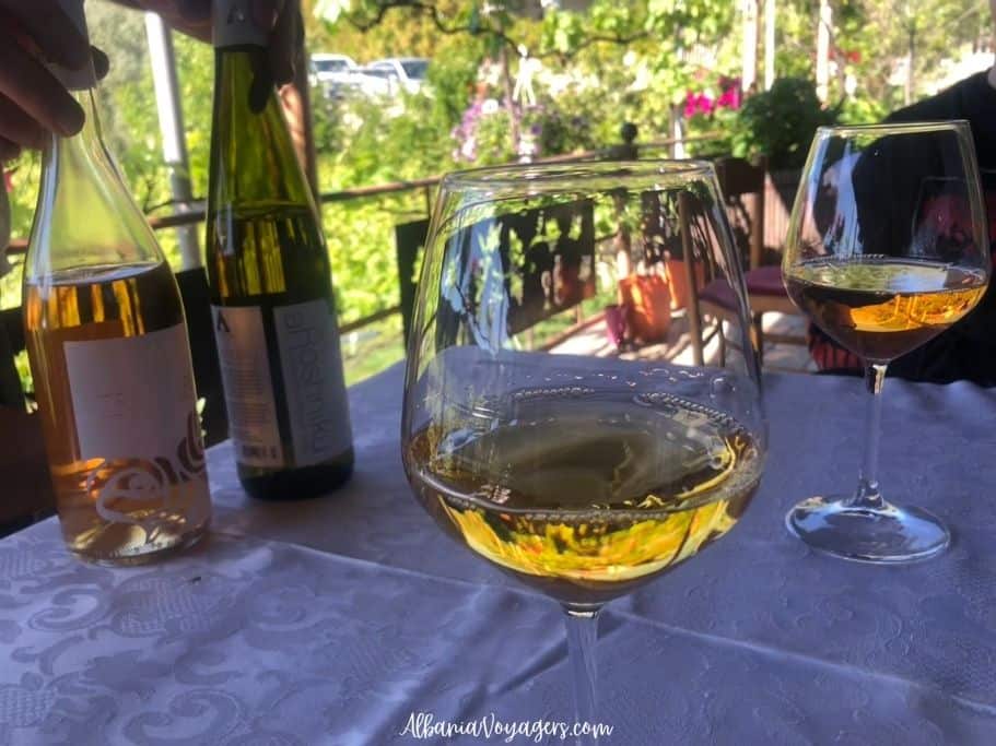 glass of rose and white wines and wine bottles on table at Alpeta Winery near Berat