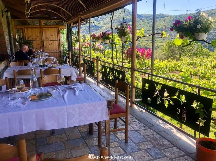 outdoor terrace with white table cothed table overlooking vineyards at Alepta Winery