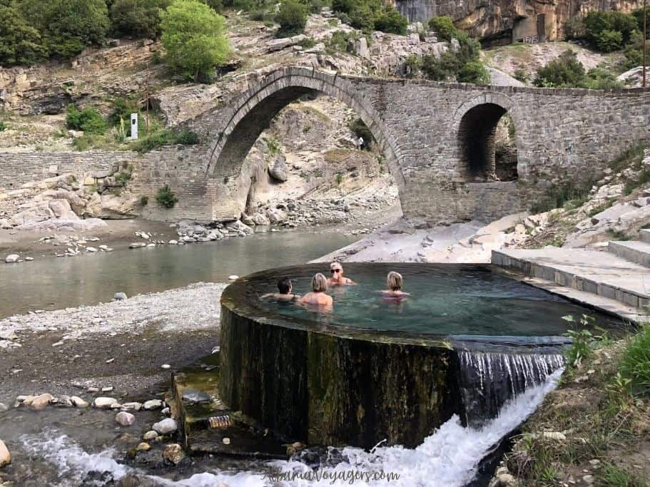 one of the large thermal pools at Benja Hot Springs, Albania with views of Ottoman era stone bridge