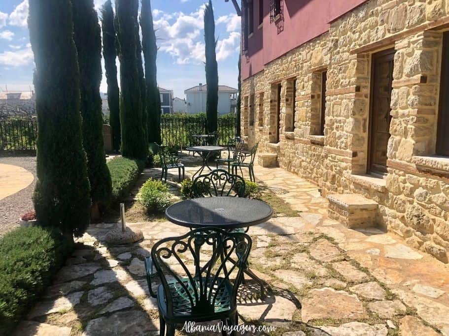 outdoor stone terrace with cypress trees at Blerina Concept guest house in Albania