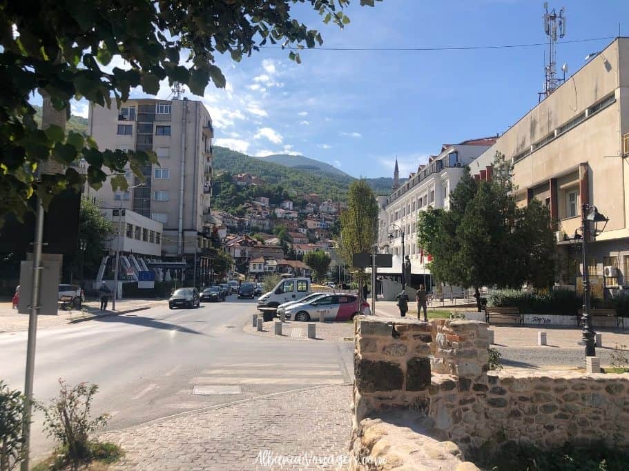 main street in Prizren, Kosovo on sunny day with montains in background