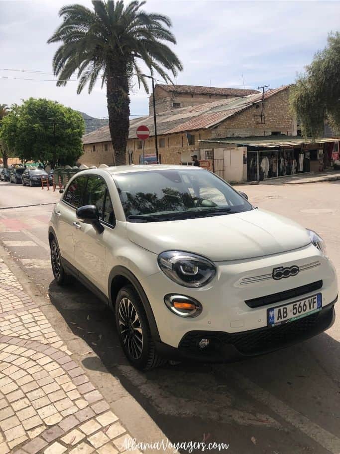white SUV rental on a road in Saranda
